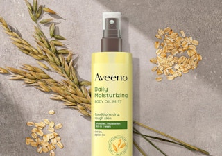 a bottle of oil mist spray on a grey surface with grains