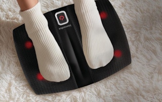a person with their feet on a foot massager