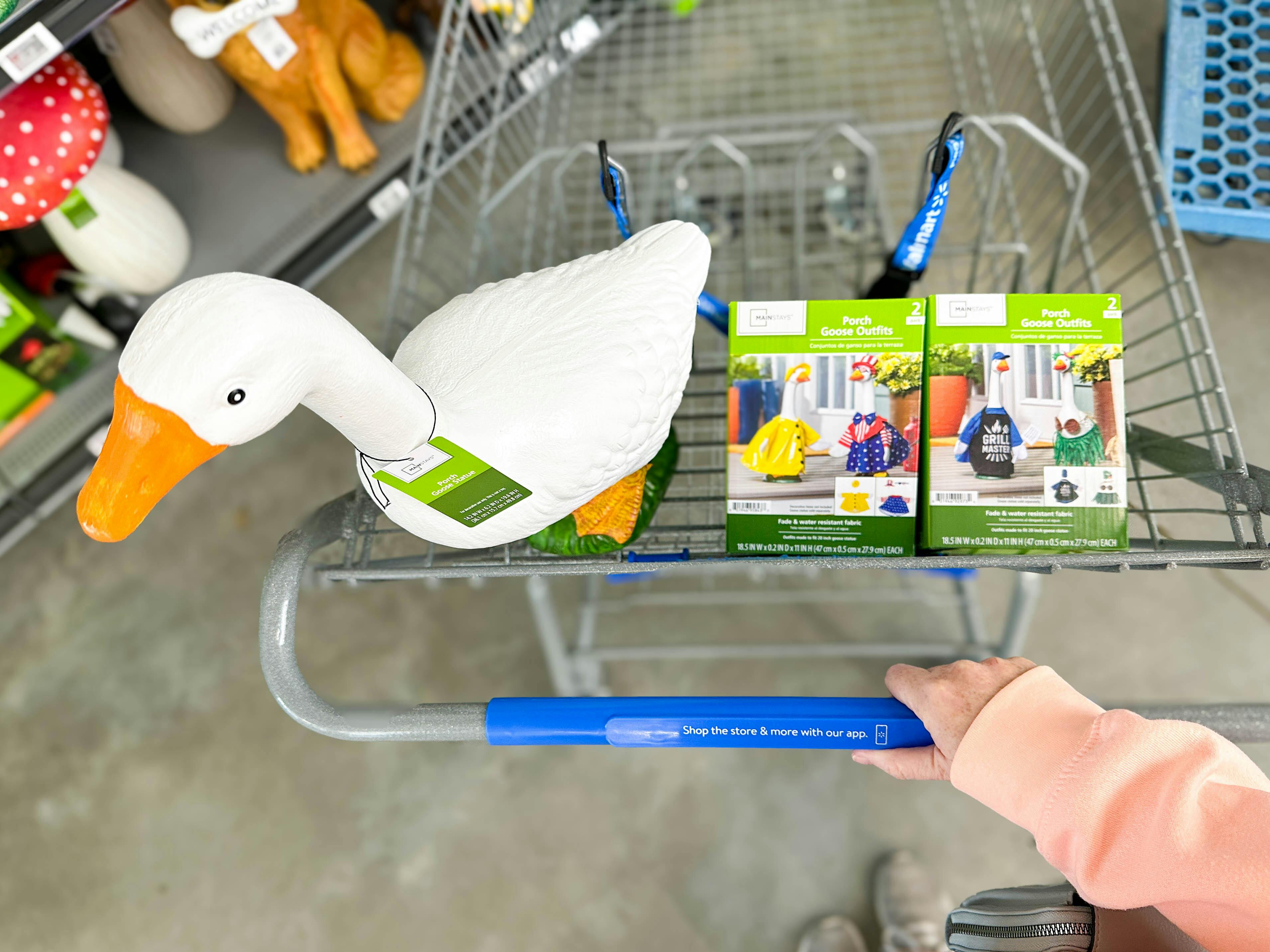 hand pushing cart with mainstays porch goose and two outfits