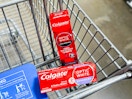 two packages of Colgate Optic White toothpaste in a Walmart cart