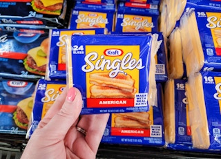hand holding a pack of kraft american cheese singles