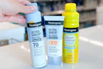 hand grabbing neutrogena sunscreen