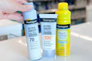 hand grabbing neutrogena sunscreen