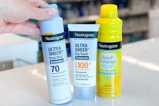 hand grabbing neutrogena sunscreen