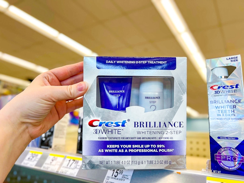 person grabbing a crest whitening kit off a shelf