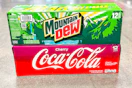 cherry coke and mountain dew stacked on floor