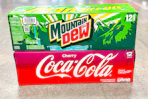 cherry coke and mountain dew stacked on floor