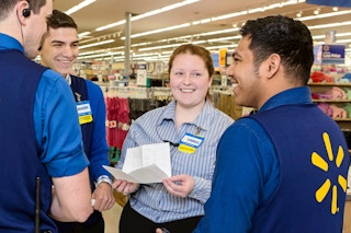 Some Walmart employees talking to each other before a shift