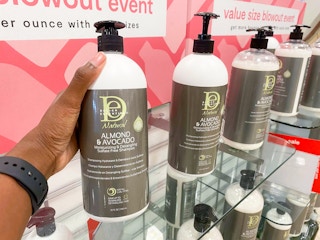 hand holding jumbo shampoo bottle