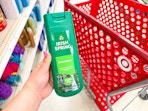 hand holding a bottle of irish spring body wash in front of a target cart