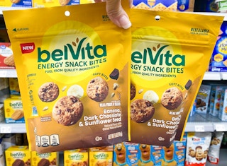 hand holding two belvita energy snack bites in walmart aisle