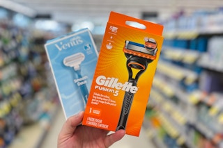 hand holding venus and gillette razors