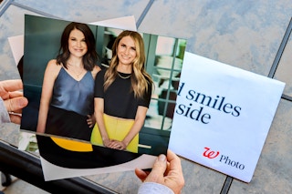 person holding walgreens 8x10 photo print with heather and joanie