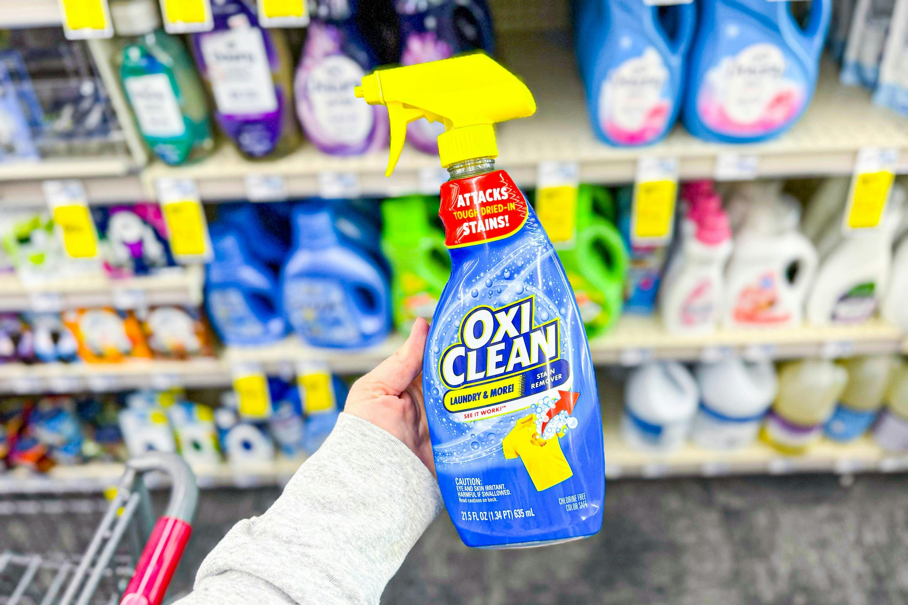 person holding a bottle of oxiclean laundry stain remover