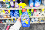 person holding a bottle of oxiclean laundry stain remover