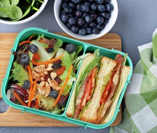 green bento box with food inside