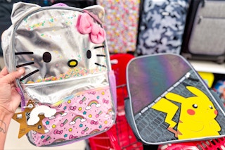hand holding a Hello Kitty backpack next to Pokemon backpack inside cart