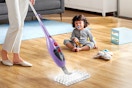woman using steam mop on hardwood floors