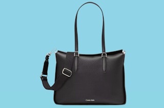 a black calvin klein tote on a blue background