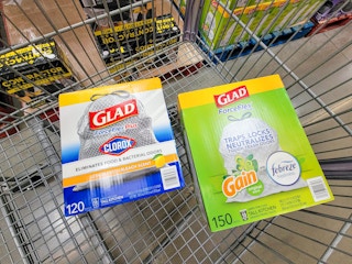2 large boxes of glad trash bags in a cart
