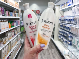 hand holding 2 bottles of jergens lotion at target