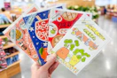 hand holding trader joes greeting cards