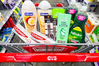 colgate toothpaste, softsoap body wash, covergirl eyeliner, garnier shampoo, and palmolive dish soap in a cart