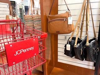 display of clearance handbags hanging on hooks
