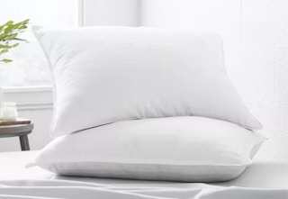 two white pillows on a bed