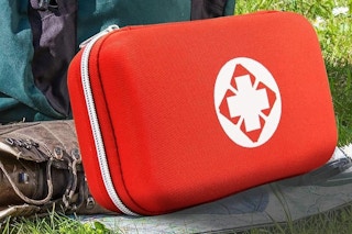 a first aid kit on the grass