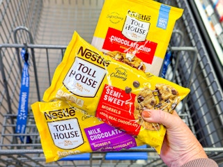 hand holding two nestle toll house chocolate chips and cookie dough over walmart cart