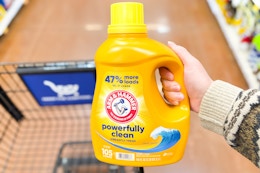 hand holding a bottle of arm hammer detergent