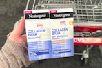 hand holding two boxes of neutrogena collagen bank moisturizer