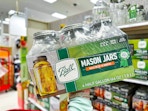 hand holding a ball half gallon mason jar set in front of target shelves