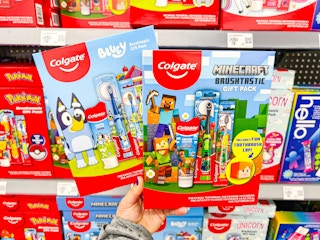 hand holding a bluey and minecraft colgate kids gift sets in walmart aisle