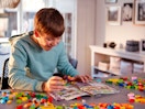 a child looking at a lego life magazine 