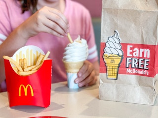 close up for girl dipping fries in ice cream
