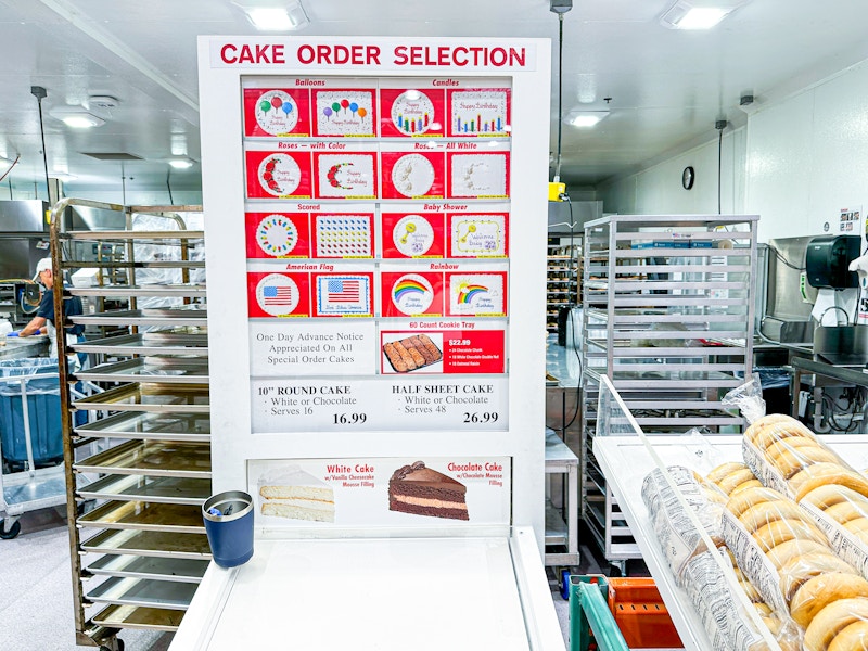 The Costco sheet cake ordering station, with images of the cake designs and flavors available.