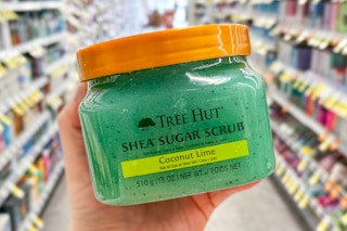hand holding body scrub in store aisle