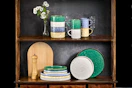 Lifestyle image of 16-piece dinnerware set on cabinet shelf