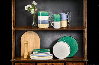 Lifestyle image of 16-piece dinnerware set on cabinet shelf