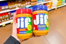 hand holding jars of jif peanut butter