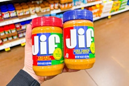 hand holding jars of jif peanut butter