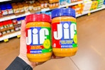 hand holding jars of jif peanut butter