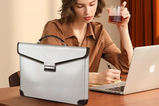 a woman working near a document bag