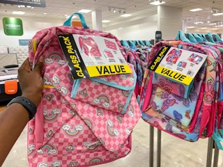 hand holding kids backpack set