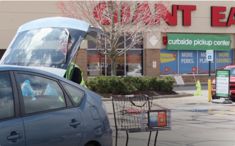 An employee loading groceries into a customers car in the Giant Eagle grocery store parking lot.