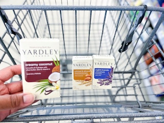 hand holding box of Yardley soap with two other boxes in the shopping cart behind it
