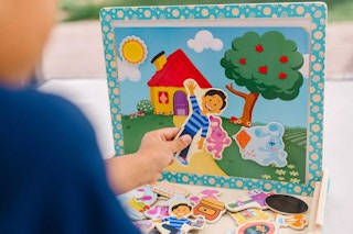 a kid playing with a Melissa and Doug Puzzle