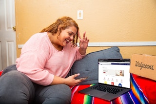 Person looking at a laptop showing the walgreens website